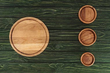 top view of various types of wooden round cutting boards on table  clipart
