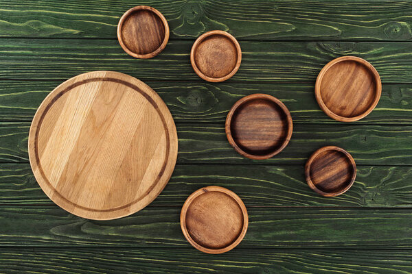 top view of different types of wooden round cutting boards on table 