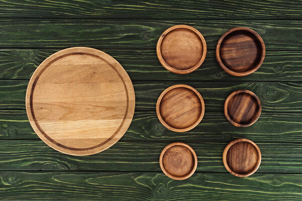 various types of wooden round cutting boards on table 
