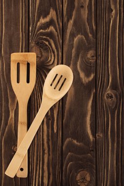 top view of two different wooden spatulas on table  clipart