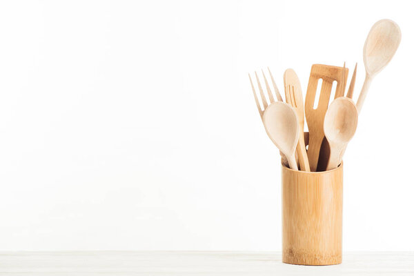 closeup view of wooden kitchen utensils isolated on white background
