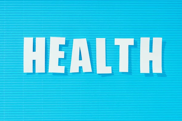 白色词健康在明亮的蓝色条纹背景 健康概念 — 免费的图库照片