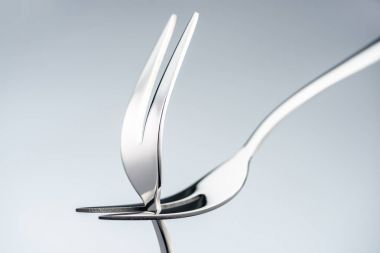 shiny forks with two tines isolated on grey clipart