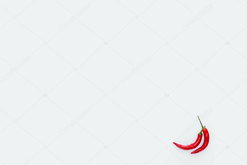 top view of two red chili peppers isolated on white