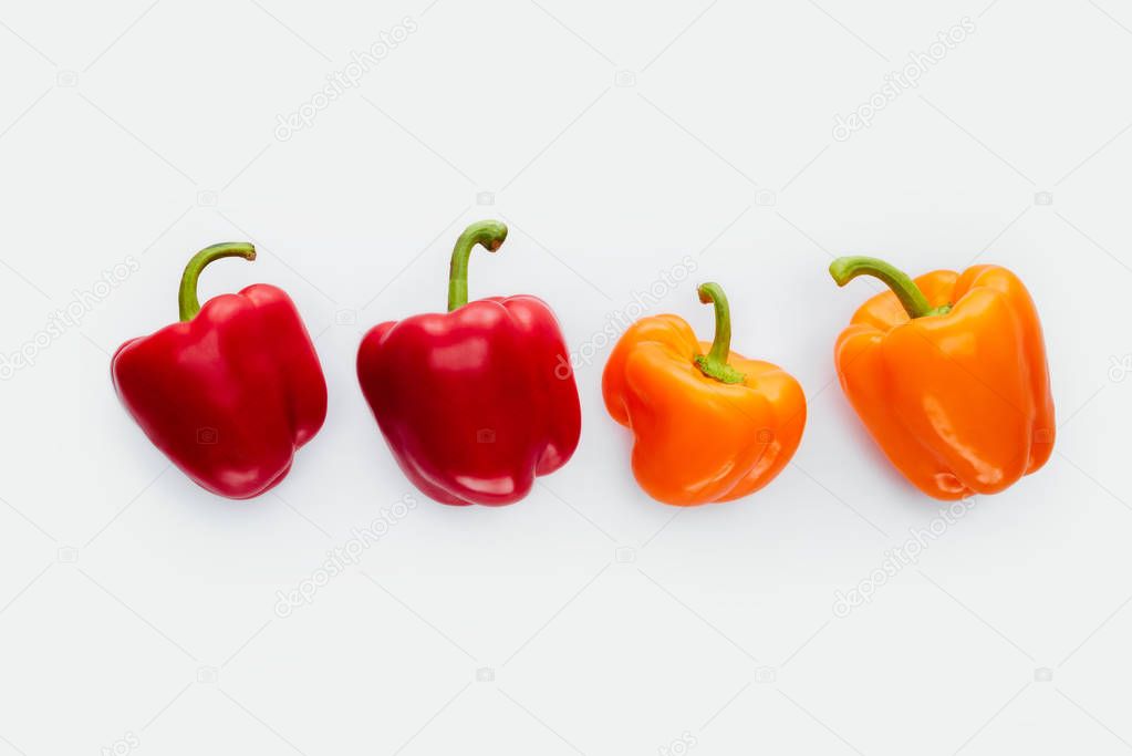 top view of red and orange bell peppers isolated on white