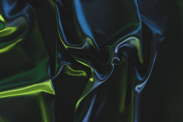 full frame of dark elegant silk fabric as background