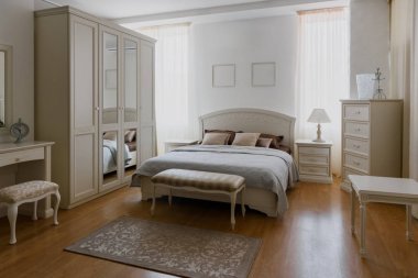 Light linen on bed in elegant bedroom with mirror clipart