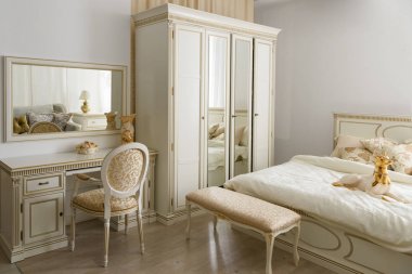 Elegant dressing table by bed in stylish room clipart