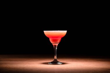 red alcohol cocktail on wooden table clipart