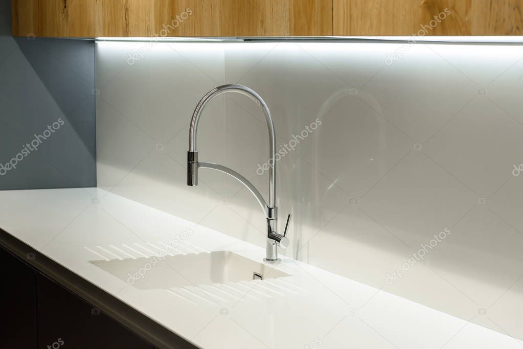 Close-up view of white sink in renovated kitchen