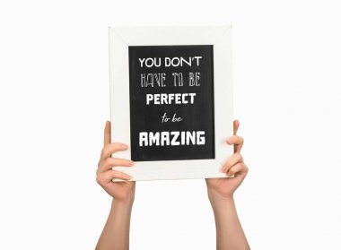Cropped view of woman holding chalkboard with inscription you dont have to be perfect to be amazing isolated on white clipart