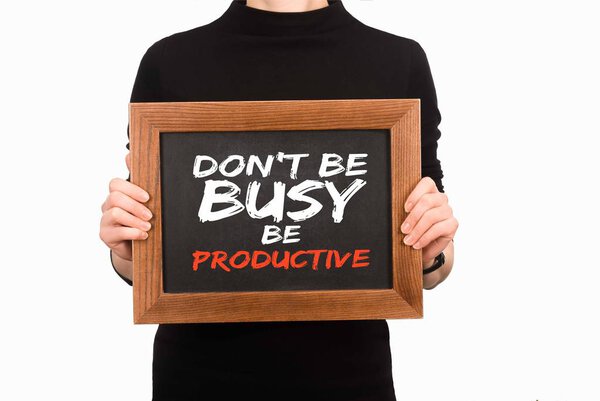 Cropped image of woman holding wooden board with inscription dont be busy be productive isolated on white