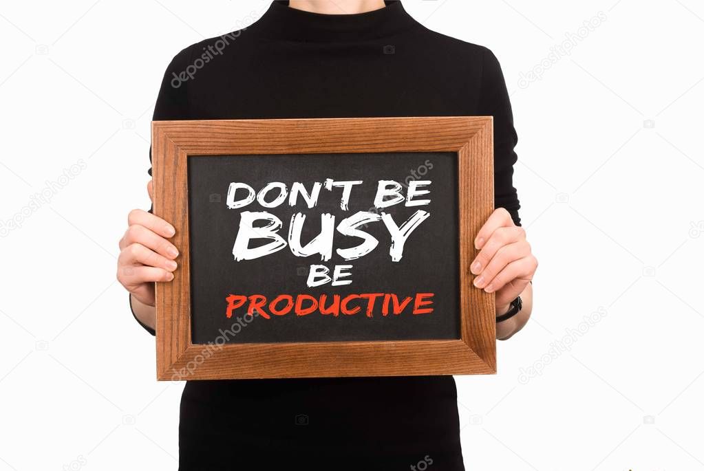 Cropped image of woman holding wooden board with inscription dont be busy be productive isolated on white