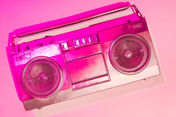pink toned picture of retro boombox on pink background 