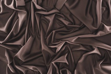 full frame of folded dark silk cloth as background clipart