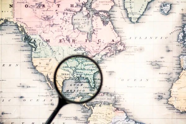 top view of magnifying glass on world map over gulf mexico