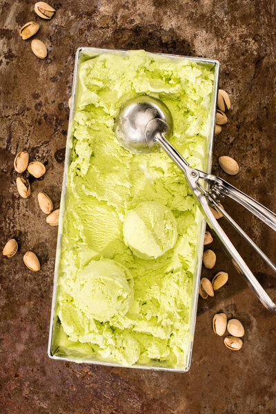 top view of pistachio ice cream with ice cream scoops on table