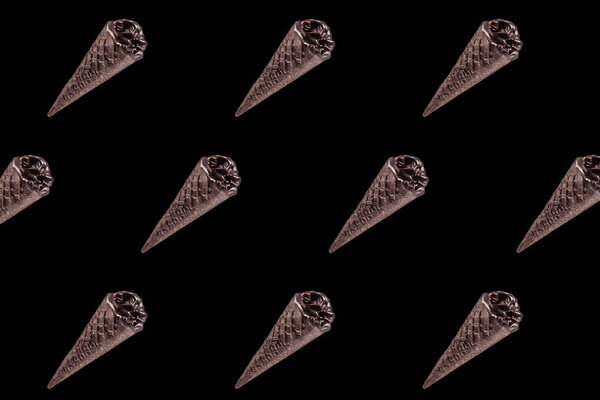 top view of pattern of chocolate black ice cream isolated on black