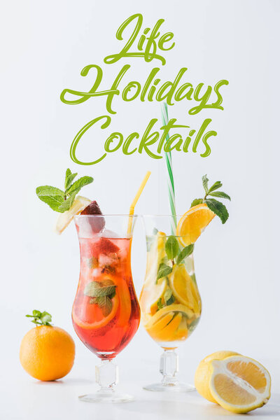 close up view of summer fresh cocktails with lemon and orange pieces, mint, life holidays cocktails lettering isolated on white