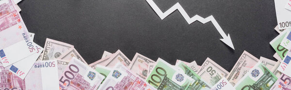 panoramic shot of white recession arrow near dollar and euro banknotes on black background