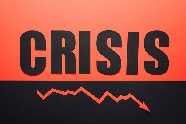 top view of word crisis and recession arrow on black and red background divided horizontally