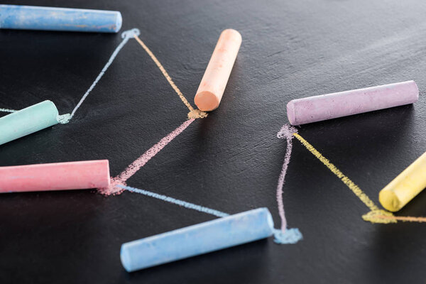 colorful chalk on black surface with connected drawn lines, connection concept