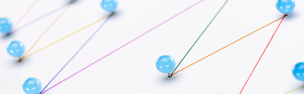 close up view of colorful connected drawn lines with pins, connection concept