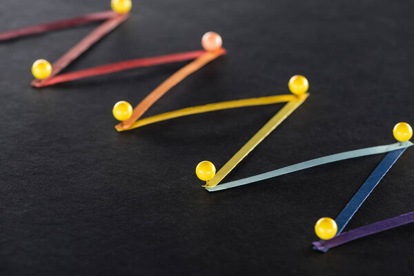 разноцветные абстрактные связные линии с булавками на черном фоне, связь и коммуникационная концепция
