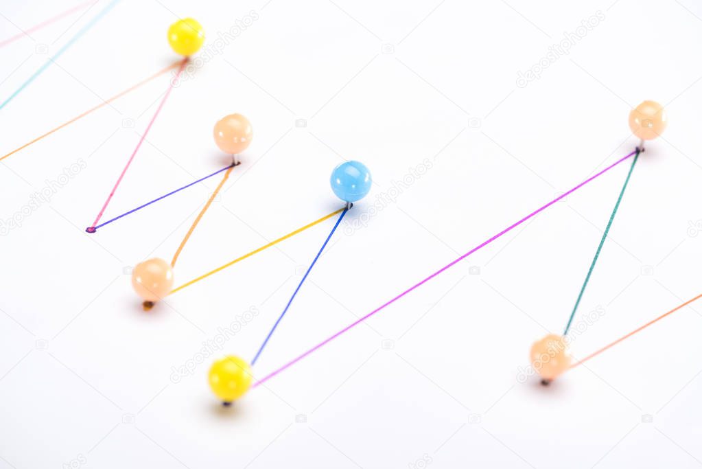 close up view of colorful connected drawn lines with pins, connection concept