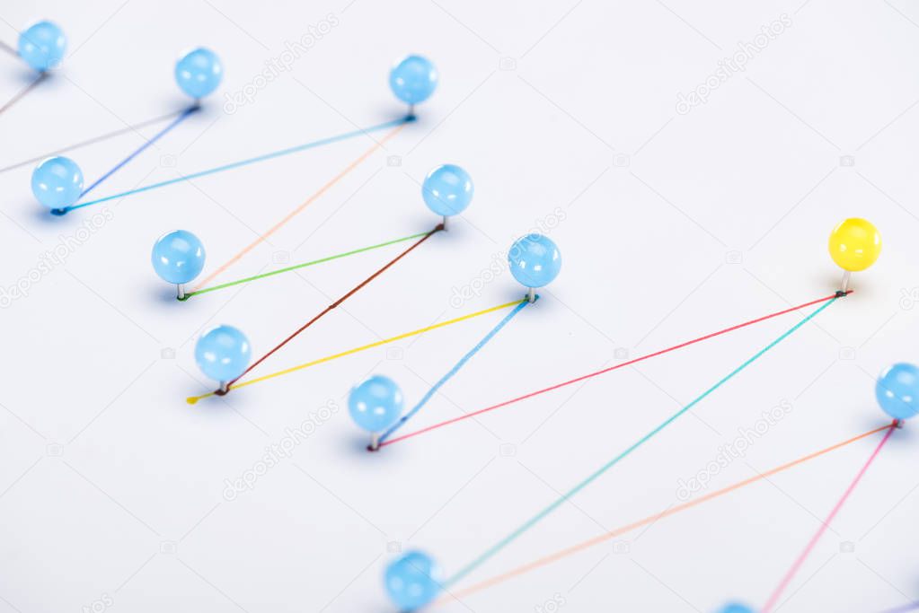 close up view of colorful connected drawn lines with pins, connection and leadership concept