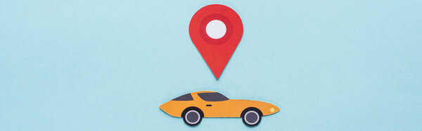 top view of paper cut sports car with location mark on blue background, panoramic shot