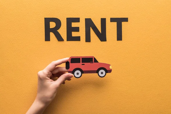 Cropped View Woman Holding Paper Cut Car Rent Lettering Orange — Stock Photo, Image
