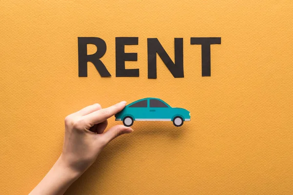 Cropped View Woman Holding Paper Cut Car Rent Lettering Orange — Stock Photo, Image