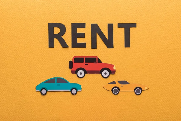 Top View Paper Cut Cars Black Rent Lettering Orange Background — Stock Photo, Image