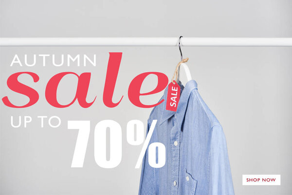 blue shirt hanging with sale label isolated on white with autumn sale, up to 70 percent illustration 