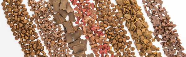 top view of fresh assorted dry pet food in lines isolated on white, panoramic shot