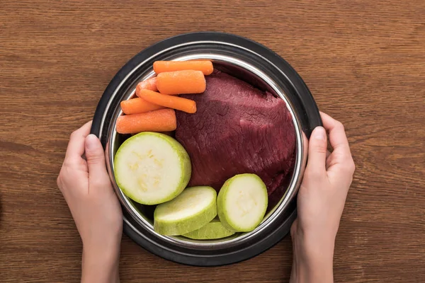 Cropped View Woman Holding Pet Bowl Raw Meat Vegetables Wooden — Stock Photo, Image
