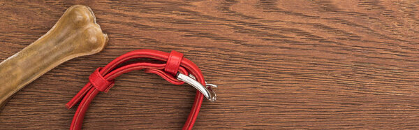 вид сверху на кость и воротник животного на деревянном столе, панорамный снимок
