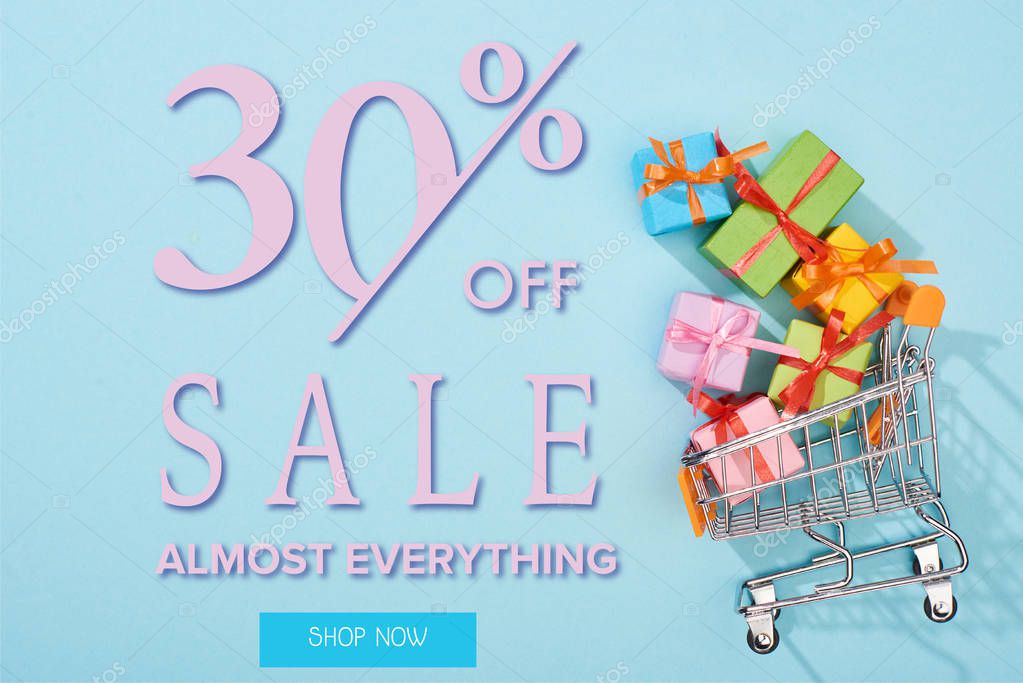 Top view of festive wrapped presents in shopping cart on blue background with 30 percent off sale illustration