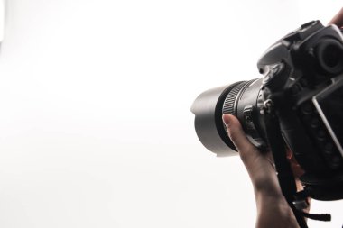 cropped view of photographer working with digital camera isolated on white clipart