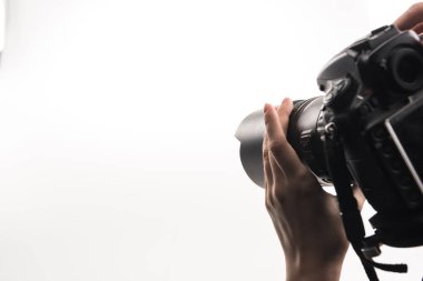 cropped view of photographer working with digital camera isolated on white clipart
