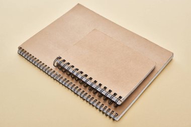 two paper blank notebooks on beige background clipart