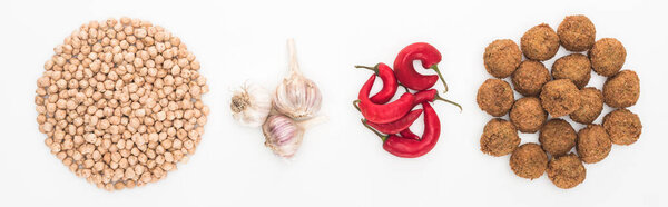 top view of chickpea, garlic, chili pepper and falafel on white background, panoramic shot
