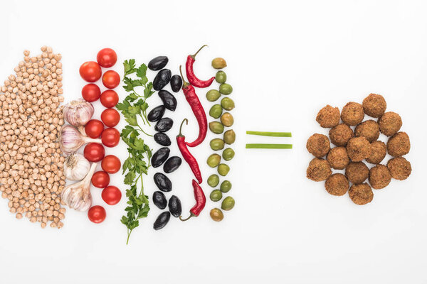 top view of chickpea, garlic, cherry tomatoes, parsley, olives, chili pepper, green onion and falafel on white background