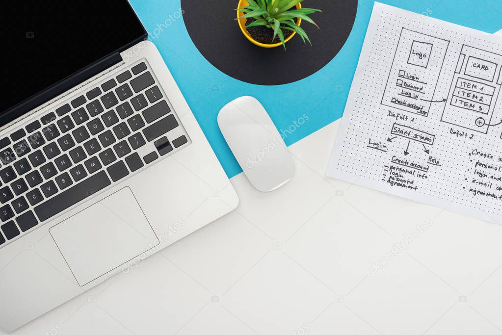 top view of laptop, computer mouse, plant, website design template on abstract geometric background