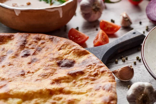 Traditional Georgian imereti khachapuri with vegetables and spices on table — Stock Image Traditional Georgian Imereti Khachapuri Vegetables Spices Table Stock Image