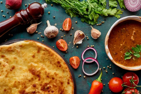 Soup kharcho and imereti khachapuri with spices and vegetables on textured green background — Stock Image Soup Kharcho Imereti Khachapuri Spices Vegetables Textured Green Background Royalty Free Stock Images