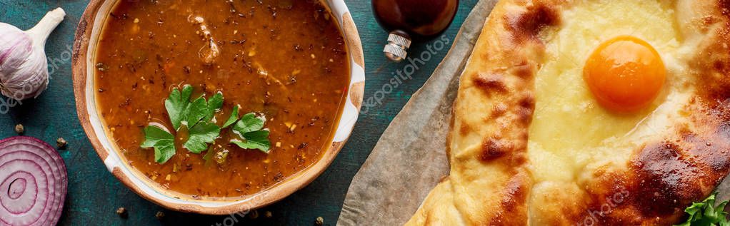 Top view of soup kharcho with cilantro and adjarian khachapuri, panoramic shot — Stock Image Top View Soup Kharcho Cilantro Adjarian Khachapuri Panoramic Shot Stock Photo