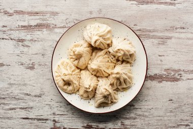 top view of delicious khinkali on wooden table