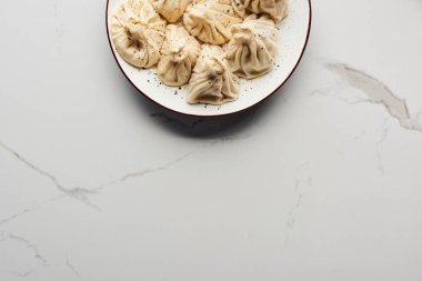 top view of fresh delicious khinkali on marble table